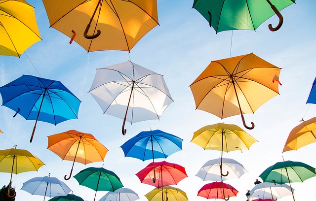Picture of numerous umbrellas appearing to be floating in the sky.